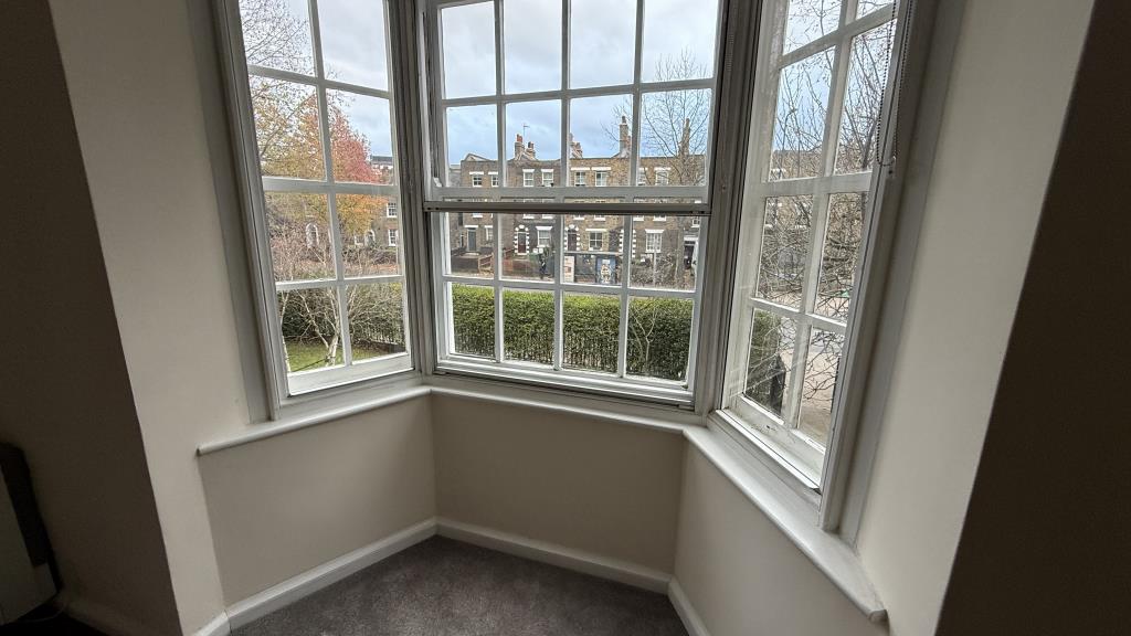 Lot: 127 - LONG LEASE TWO-BEDROOM FLAT FOR INVESTMENT OR OWNER OCCUPATION - Internal image of bay window overlooking main road
